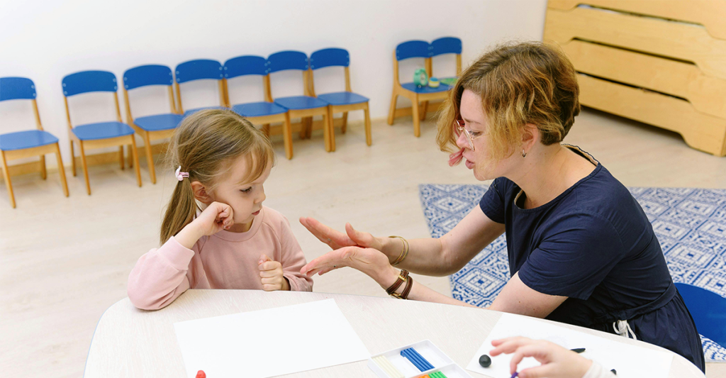 autism therapist working with young child